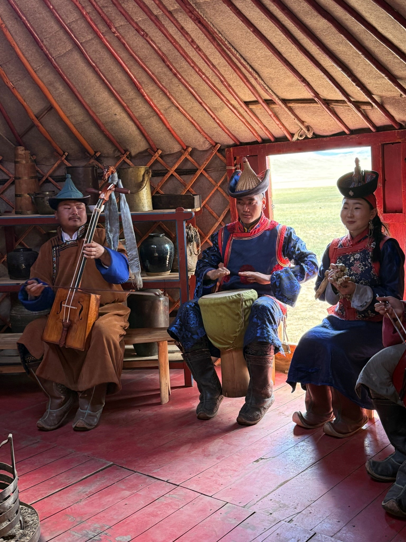 Traditional Mongolian musicians performing inside a yurt