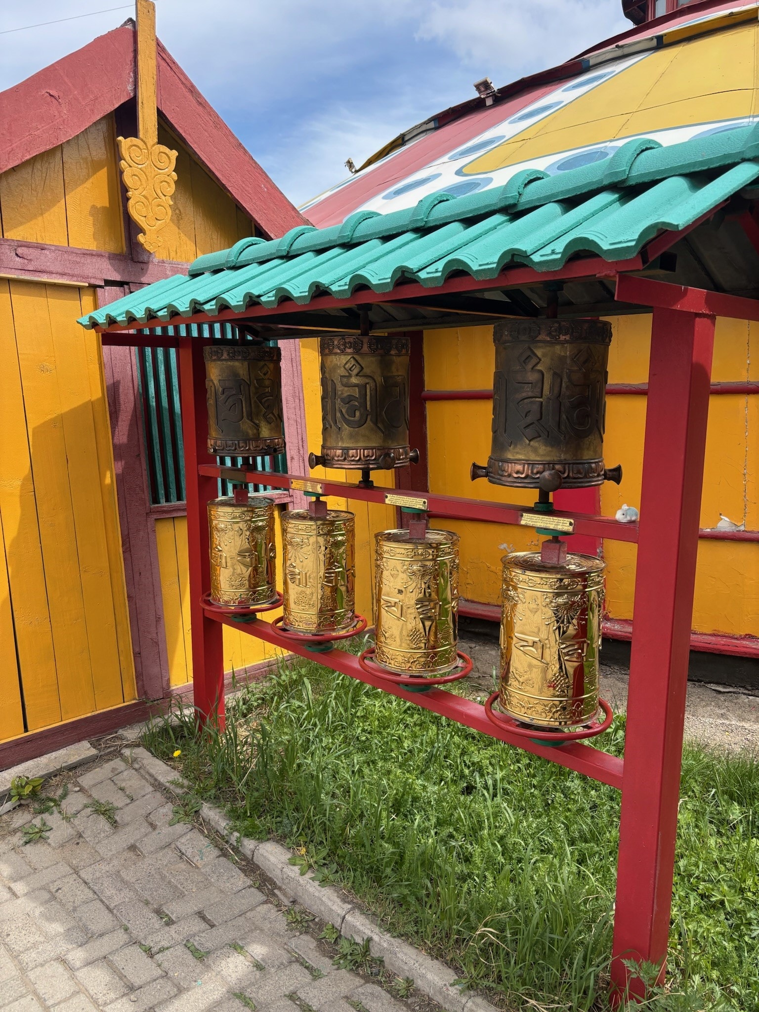 Golden Buddhist prayer wheels at a Mongolian temple